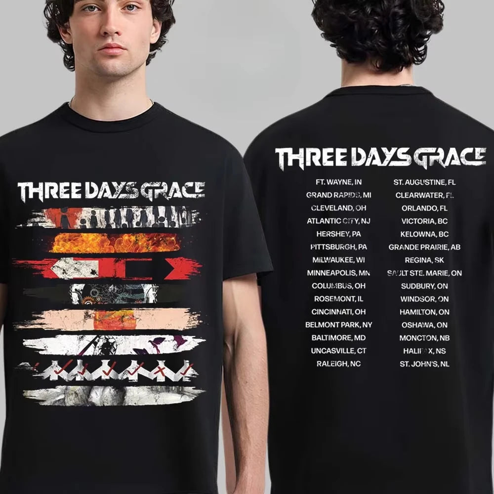 A man modeling a black graphic T-shirt, shown from the front and back against a light gray studio background. The shirt features the text 'THREE DAYS GRACE' in white across the chest and a list of locations across the back.